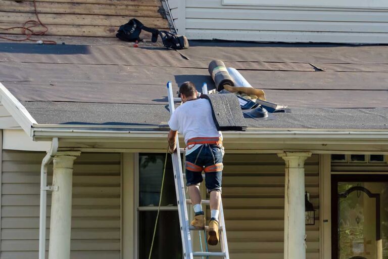 A closeup of a modern flat roof next to a traditional sloped shingle roof on neighboring homes.